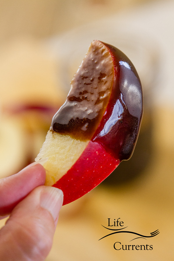 an apple slice dippd in Mocha Caramel Sauce