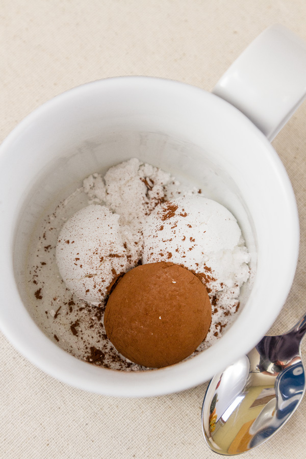 Place the cocoa and the powdered sugar in the bottom of the mug, and mix together thoroughly. 