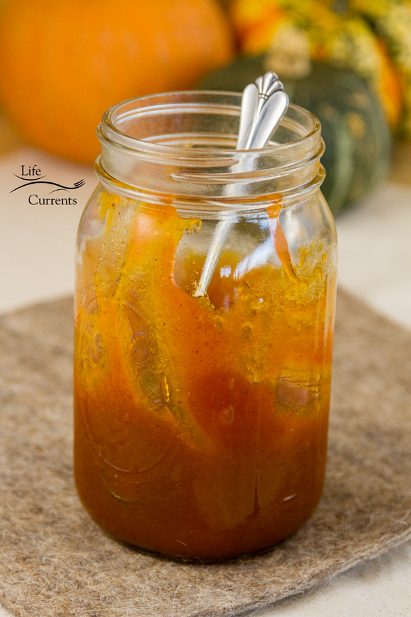 a jar of pumpkin butter with a spoon in it 
