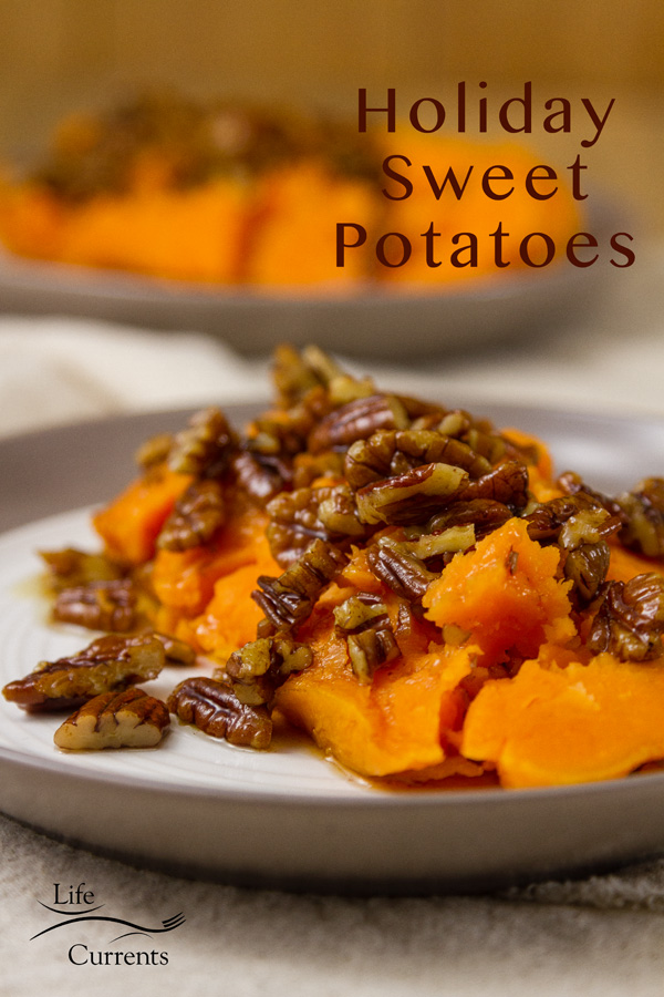 two baked sweet potatoes halves on two plates with maple brown butter pecan sauce