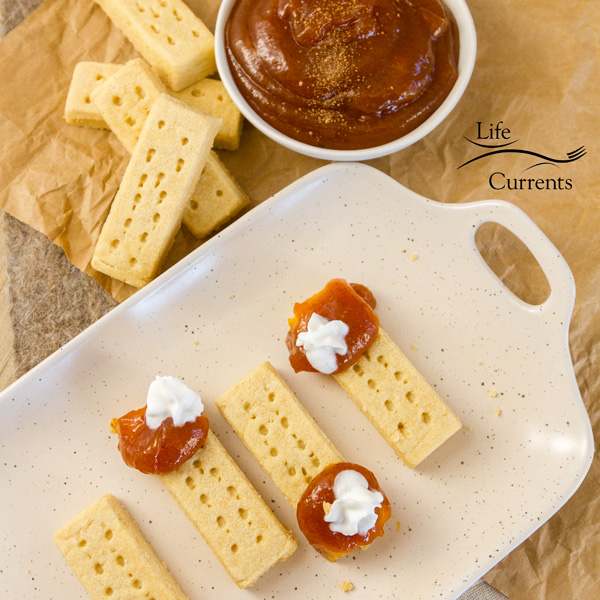 Pumpkin Butter Pie Bites Cookies on a tray with additional shortbread cookies and pumpkin butter on the side 