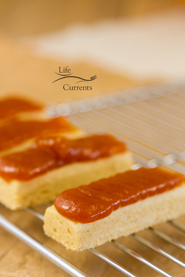 shortbread cookies with pumpkin butter on top on a cooking rack for decorating 
