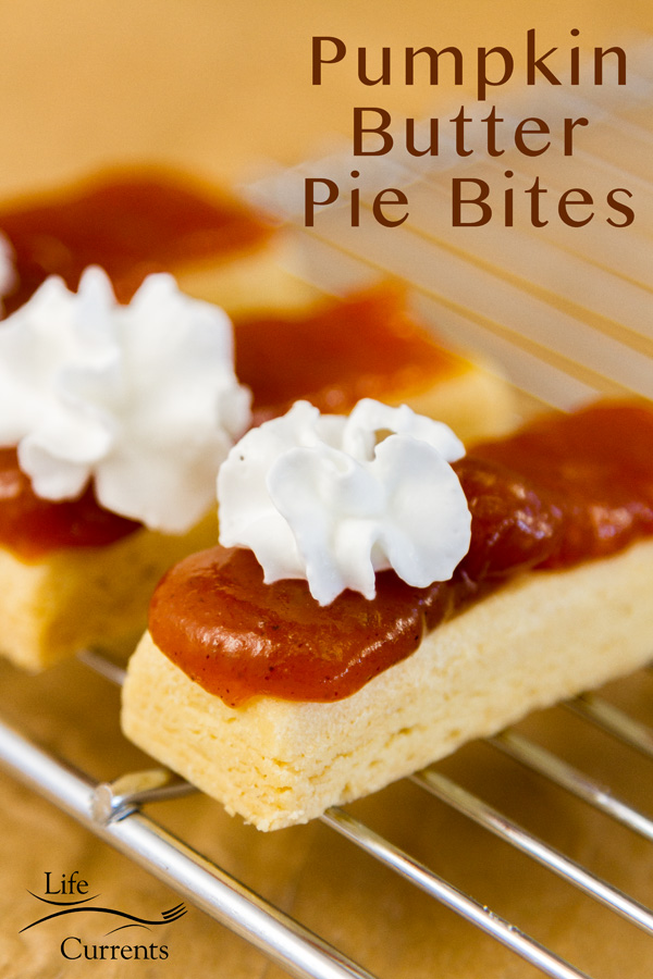 Shortbread cookies topped with pumpkin butter and whipped cream on a cooking rack with a title 