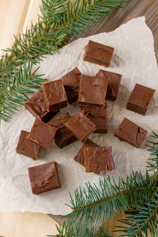 Rich smooth and creamy Mocha Fudge with the intense flavor of espresso and chocolate. This is a fudge that deserves a special place in your holiday baking and gift giving. top down or flat lay onto a pile of Mocha Fudge