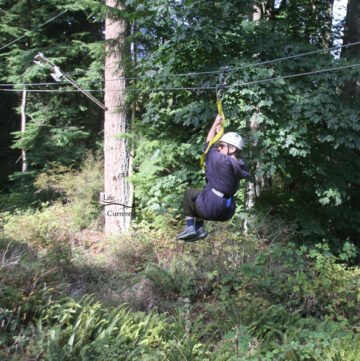 Me on a zipline in the middle of the forest