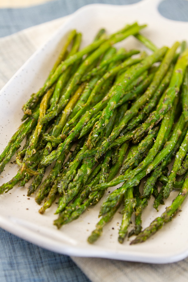Air Fryer Asparagus Cooking asparagus in the air fryer requires just 2 simple ingredients (plus salt and pepper), and is ready in a fraction of the time that it would take to oven roast it. roasted asparagus on a white platter