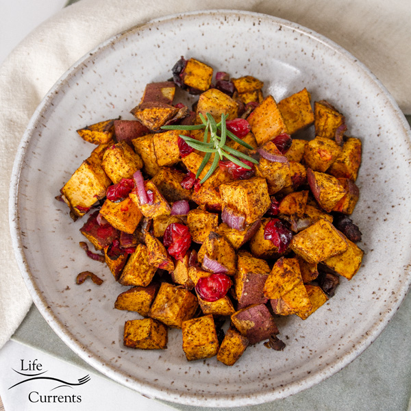 square crop of air fryer roasted sweet potatoes in a white bowl