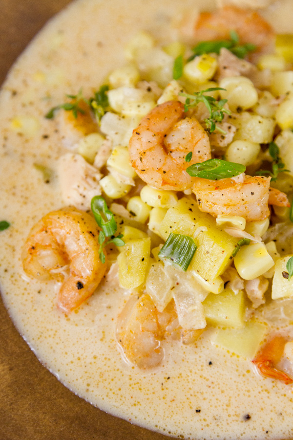 This Cajun Seafood Chowder is rich and creamy, with just the right amount of Cajun spiced seafood including shrimp and tuna, along with sweet corn and earthy potatoes. It’s perfect comfort food that will make you happy close up of Cajun seafood chowder with lots of shrimp, corn, potatoes, and tuna