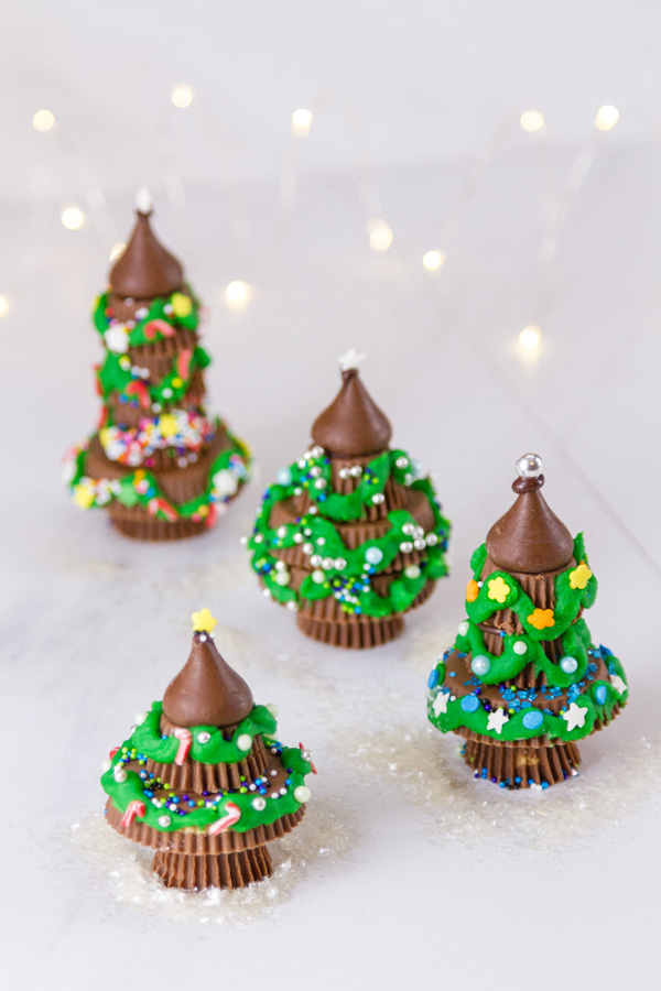 A forest of Peanut butter cup Christmas trees with twinkle lights 