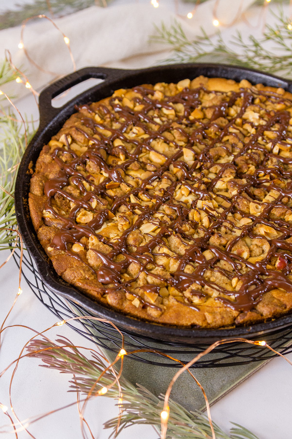 Peanut Butter Coffee Cake drizzled with chocolate in a cast iron skillet