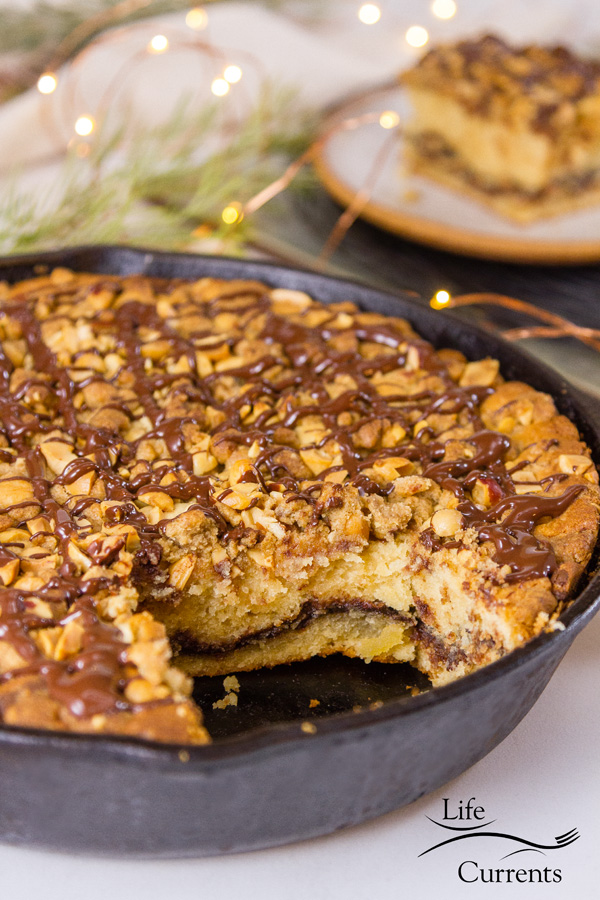 cake cooked in a skillet with a slice cut out, the slice is in the background