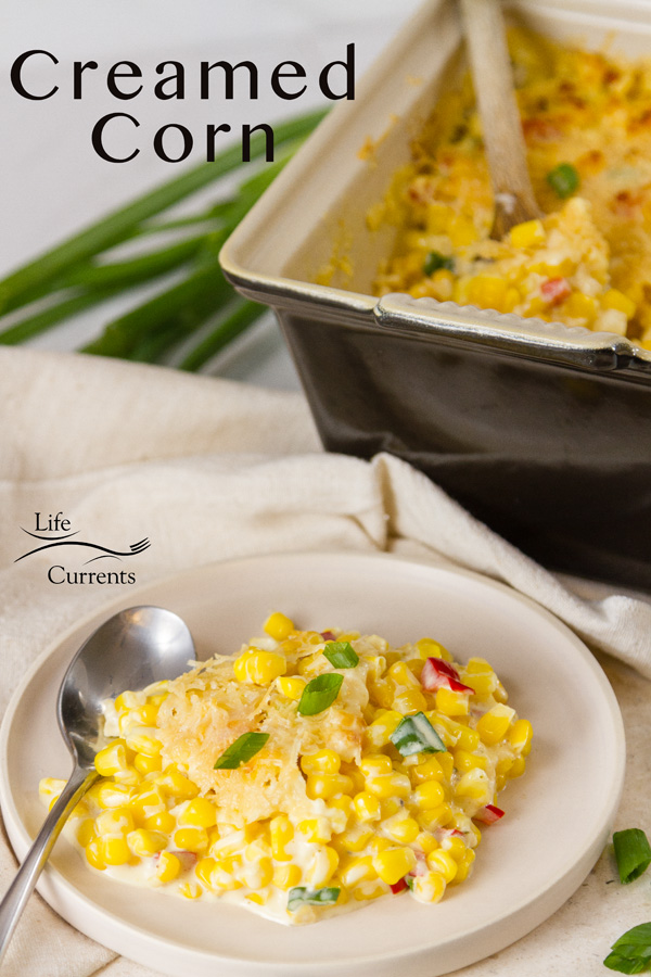 A serving of Creamed Corn on a plate with the side dish in the background and the title 