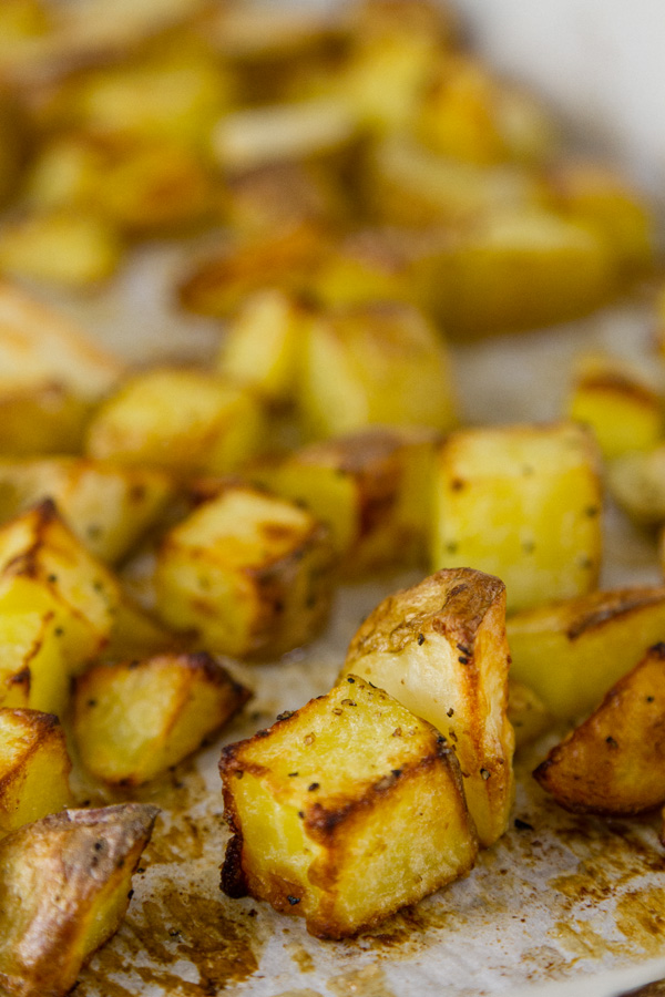 close up of Potato cubes still on the roasting sheet