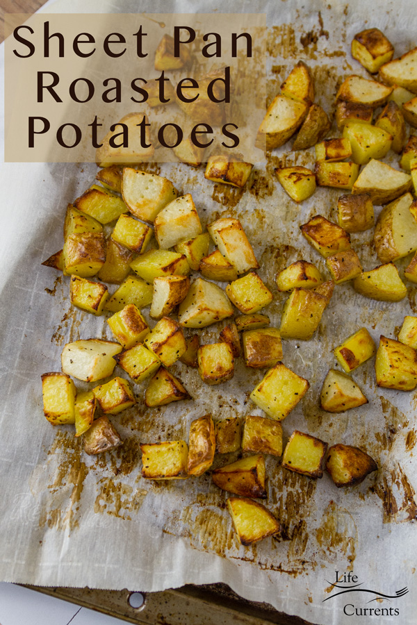 Sheet Pan Roasted Potatoes are an easy, delicious side dish for any meal. This super easy method produces perfectly cooked potatoes that are crispy outside and tender and creamy inside. Sheet Pan Roasted Potatoes on parchment paper on a sheet pan with the title