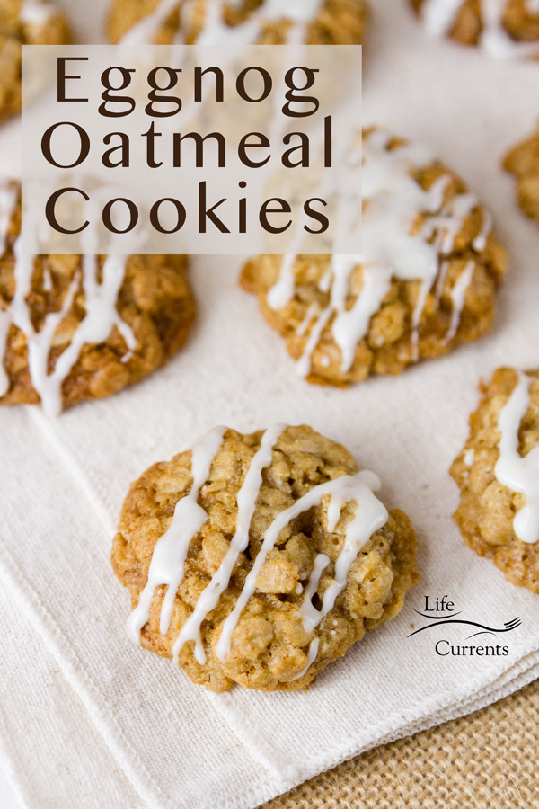 A festive version of your favorite cookies, these Eggnog Oatmeal Cookies will be your new Christmas favorite Eggnog Oatmeal Cookies with eggnog icing on an ivory napkin