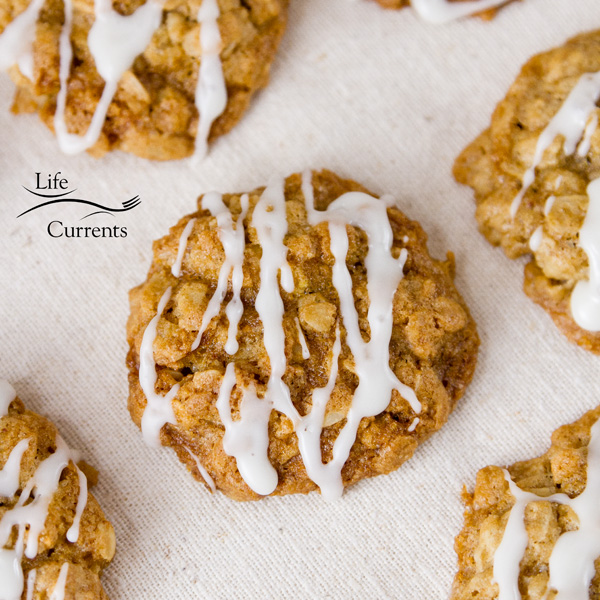Chewy Eggnog Oatmeal Cookies with crispy edges and the classic festive taste of eggnog. These will be a hit with your family and Santa. square crop of eggnog oatmeal cookies with icing on a napkin