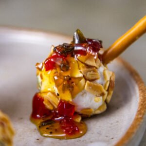 square crop of Pepper Jelly Cheese Balls with pepper jelly on top