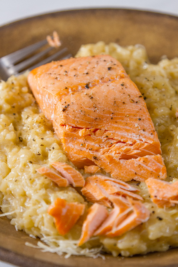 Roasted Salmon Risotto served in a brown bowl with a fork