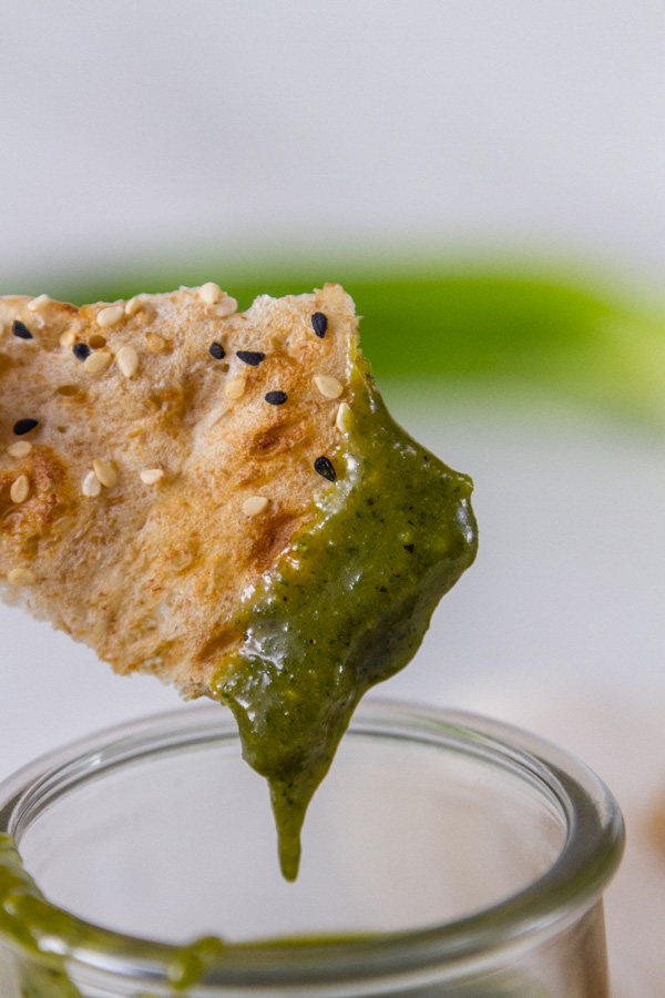 a piece of bread dipped into Tamarind Cashew Dipping Sauce 