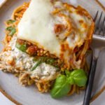 Spinach Provolone Baked Pasta top down looking at the plate with a serving on it and a fork