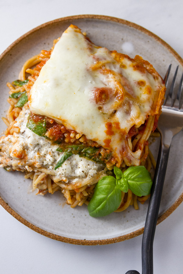 Spinach Provolone Baked Pasta top down looking at the plate with a serving on it and a fork