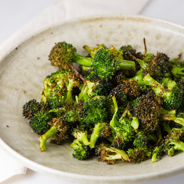 square crop of Air Fryer Roasted Broccoli in a white bowl