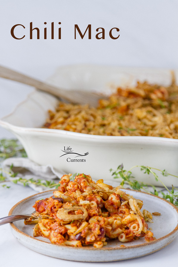 chili mac on a plate with a fork and the casserole in the background