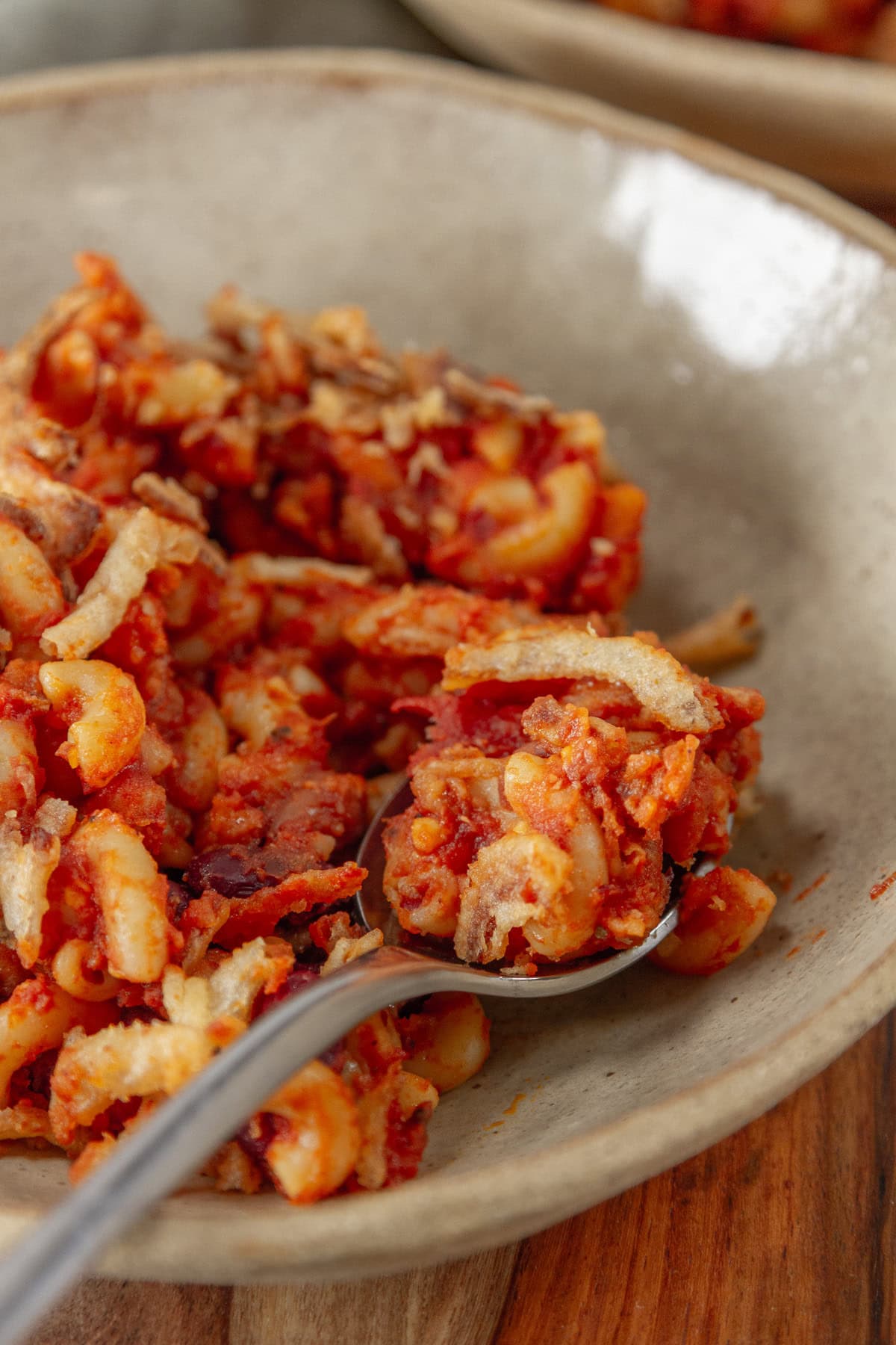 a spoon in a bowl of casserole.