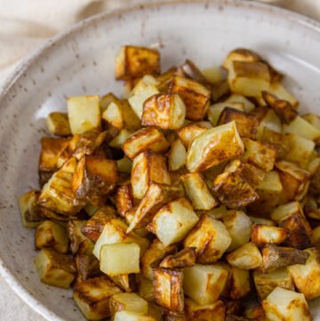 Air Fryer Potatoes in a white bowl with the title