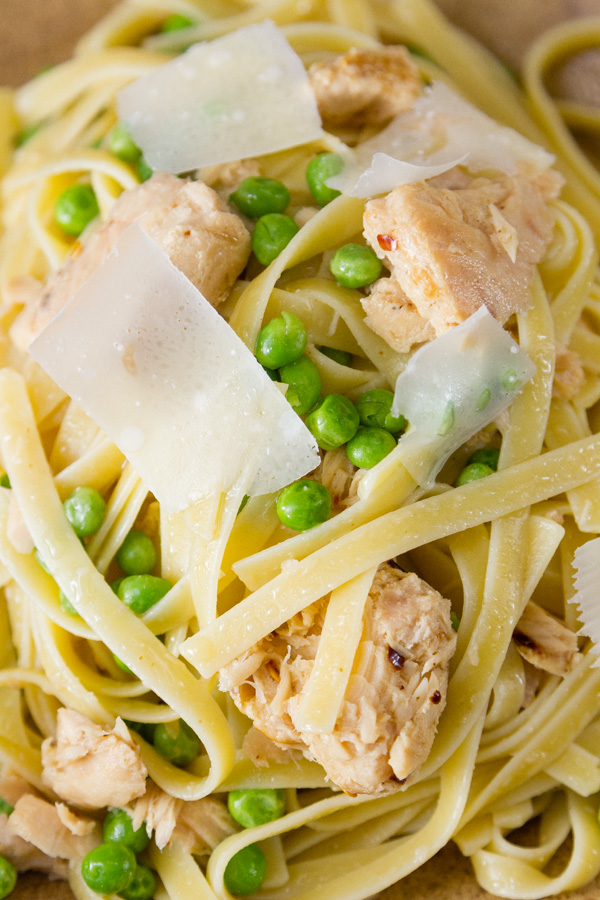 close up of Easy Weeknight Tuna Pasta Dinner with peas, parmesan, pasta, and tuna