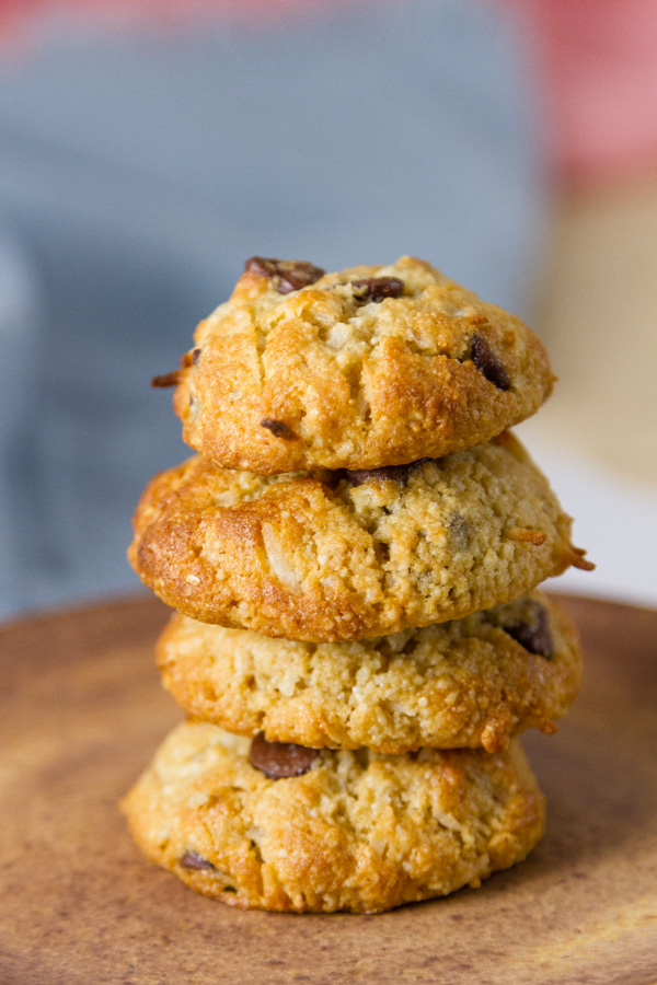 Coconut Almond Meal Cookies with Chocolate Chips stcaked up on top of each other with a blue cloth in the background