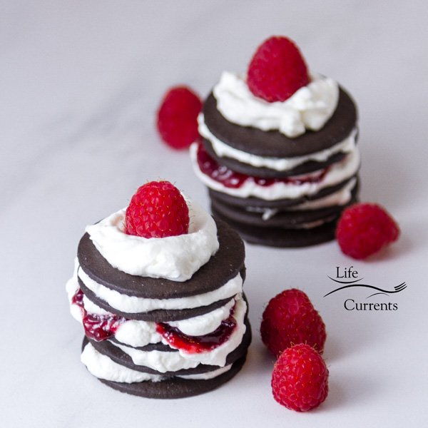square crop of Chocolate Raspberry Icebox Cakes with 2 cakes on a white background