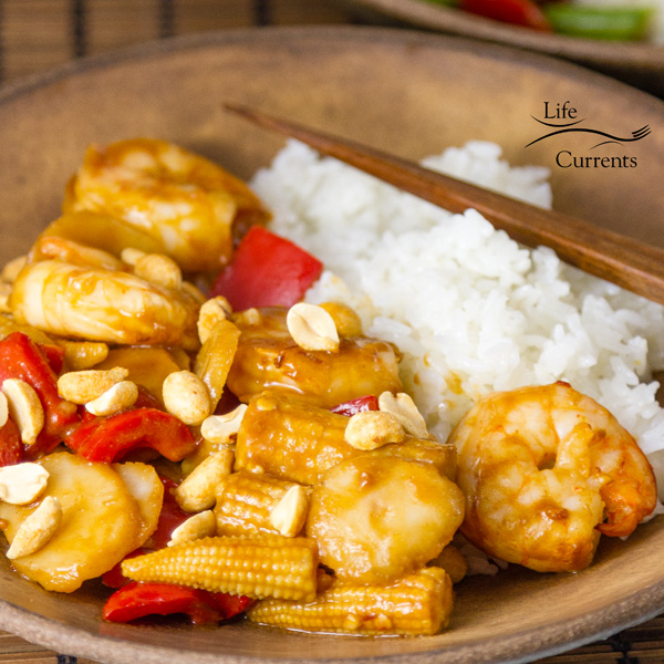square crop of Air Fryer Shrimp in a brown bowl with rice and chopsticks 