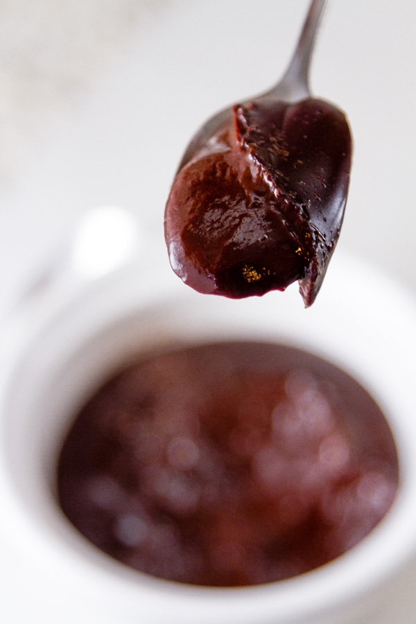 A spoonful of Chocolate Pudding in front of the bowl of pudding 