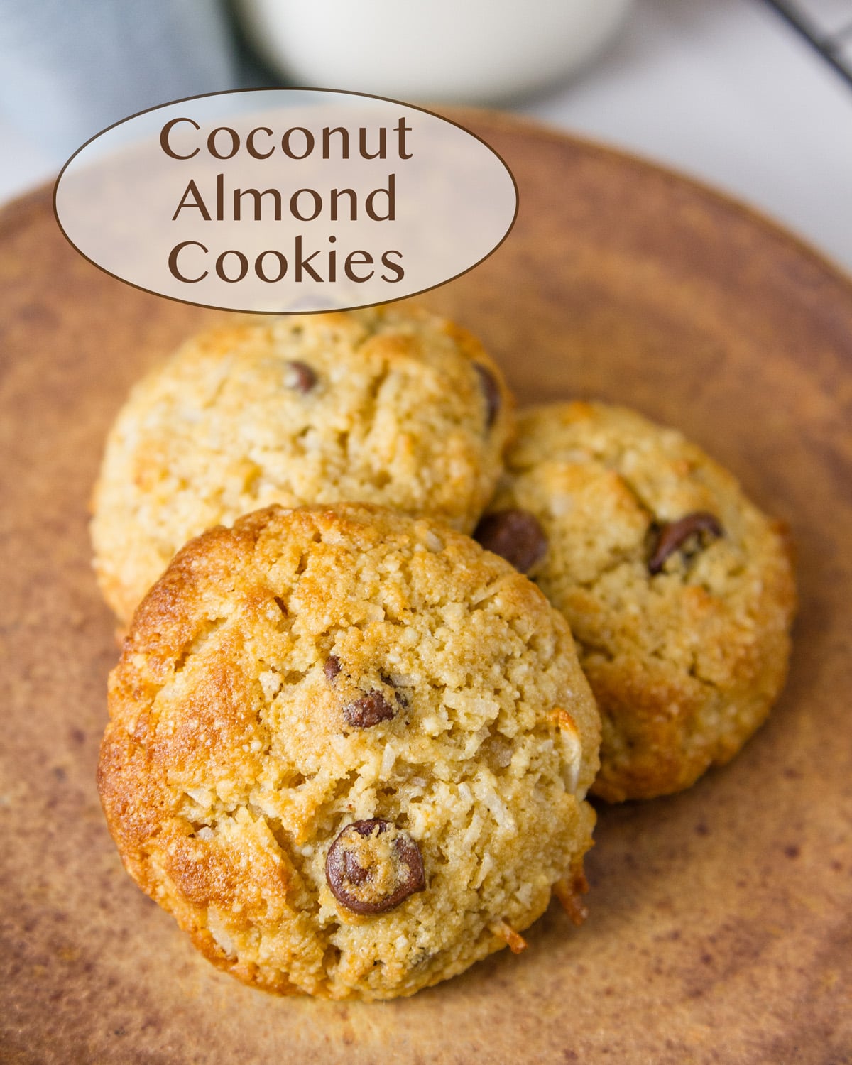 three cookies on a brown plate.