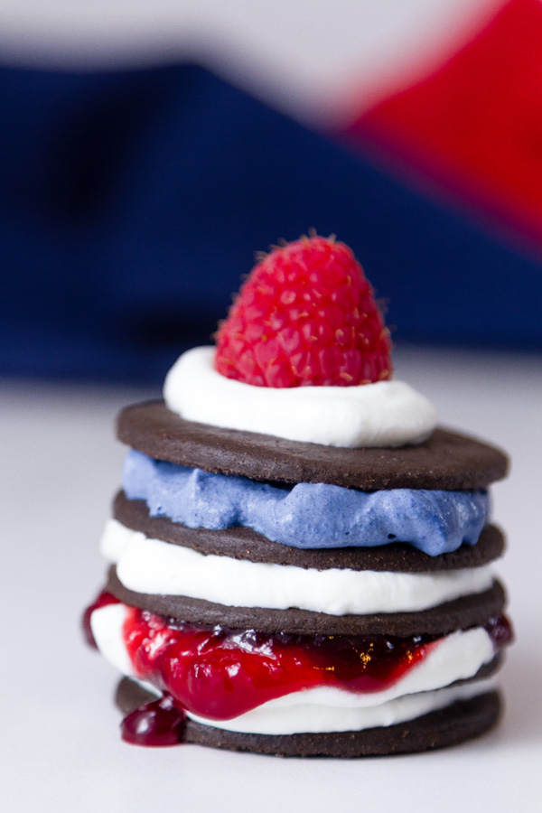 Patriotic Icebox Cakes - a finished cake all stacked with cookies and whipped cream and topped with a raspberry 