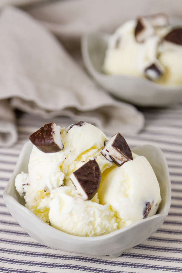 two bowls of ice cream garnished with York Peppermint Patty pieces on a blue and white striped background