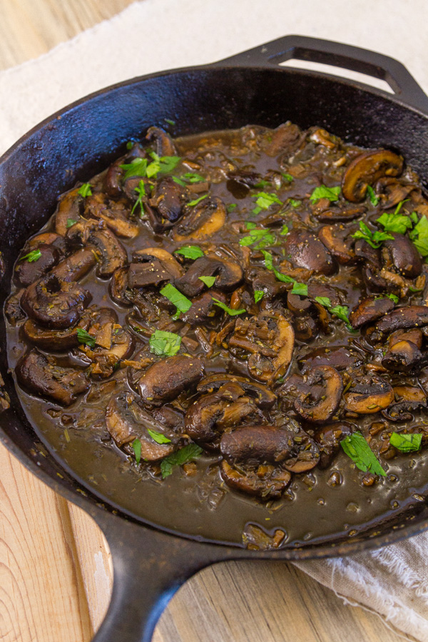 freshly cooked Mushroom Ragout in a cast iron skillet garnished with parsley 