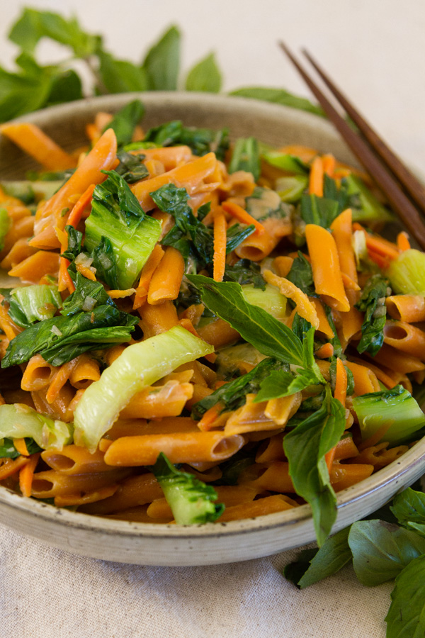 pasta and vegies in a bowl with chop sticks 