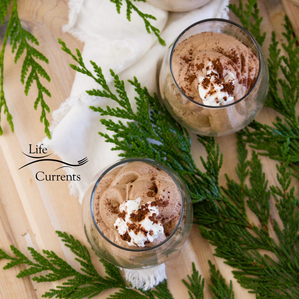 square crop of mocha mousse with evergreens and a white napkin