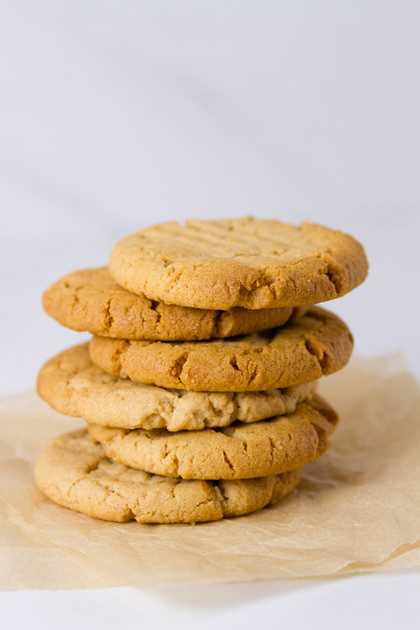 a stack of cookies on parchment paper