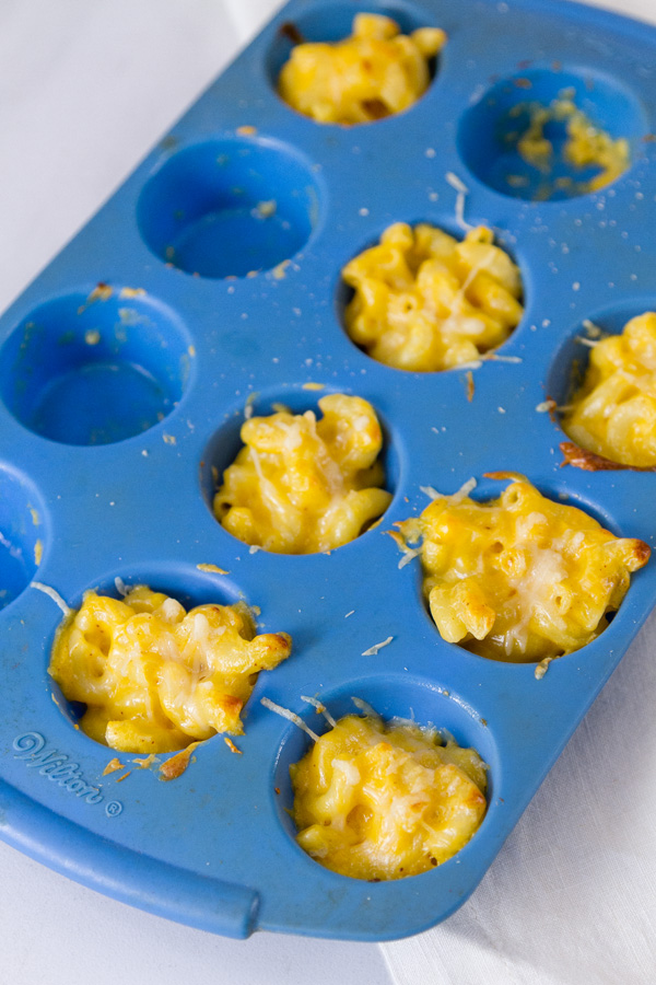 mac & cheese bites made in a blue silicone muffin tray