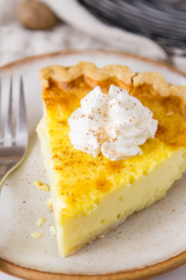 close up on a slice of pie with whipped cream