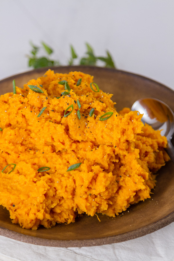 mashed sweet potatoes on a plate with a spoon