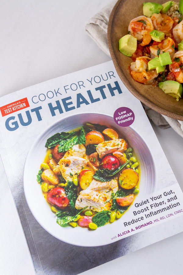 Cook for your gut health cookbook next to a shrimp bowl.