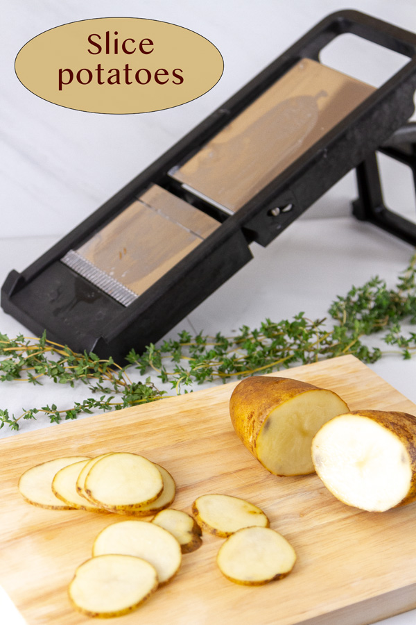 a mandoline, sliced potatoes, and a potato cut in half on a cutting board.
