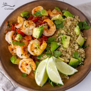 square crop of Seared Shrimp with Fresh Tomato Sauce and Cilantro Lime Quinoa top down view, served with lime wedges.