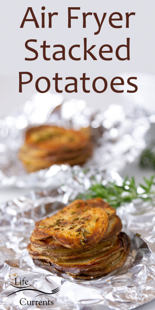 stacks of sliced and roasted potatoes in aluminum foil with fresh roasemary, title on top of image: Air Fryer Stacked Potatoes