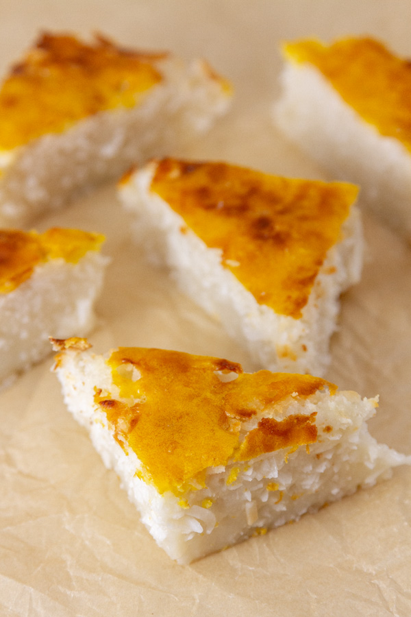 triangles of coconut cake on parchment paper.