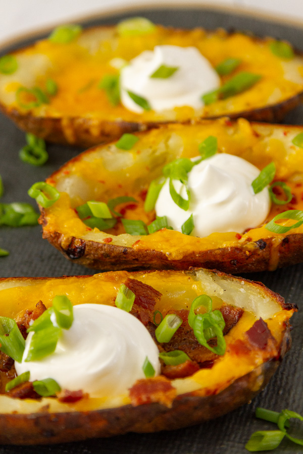 potatoes baked and filled with bacon, cheese, sour cream, and green onions.